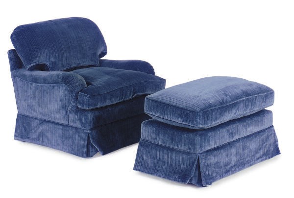 A BLUE VELVET UPHOLSTERED LOUNGE CHAIR AND OTTOMAN,