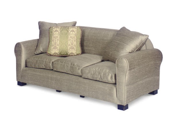 AN EBONIZED AND UPHOLSTERED SOFA,