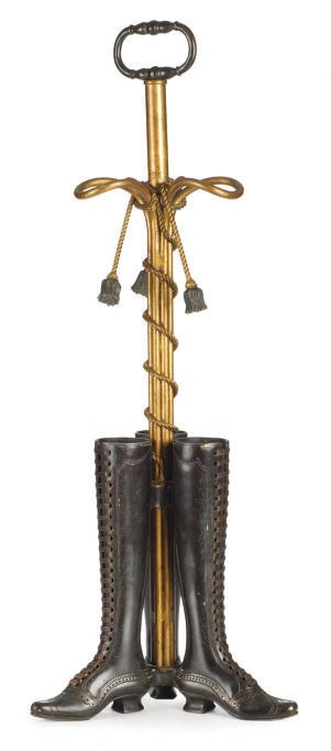 A PATINATED AND GILT-METAL THREE-BOOT UMBRELLA STAND,