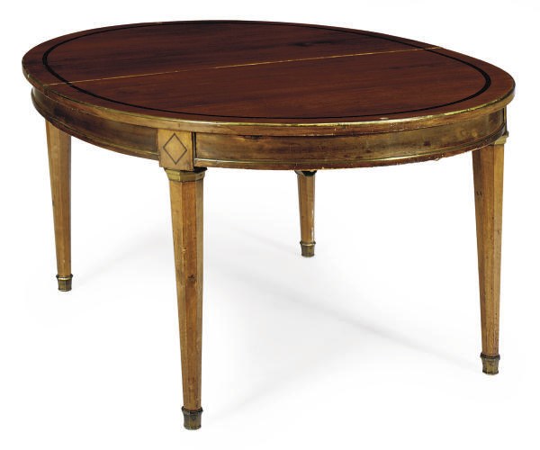 A CONTINENTAL BRASS-MOUNTED FRUITWOOD AND EBONIZED EXTENDING DINING TABLE,