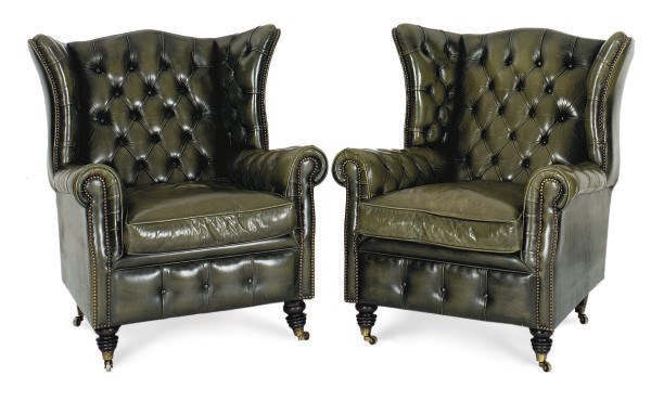 A PAIR OF GREEN LEATHER UPHOLSTERED WINGBACK ARMCHAIRS,
