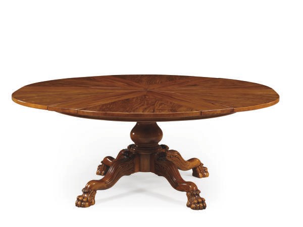 A GRAINED WALNUT EXTENDING CIRCULAR DINING-TABLE,