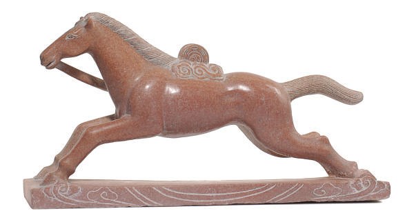 A CHINESE STYLE RED MARBLE FIGURE OF A GALLOPING HORSE,