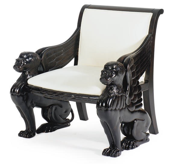 A CARVED AND EBONIZED ARMCHAIR