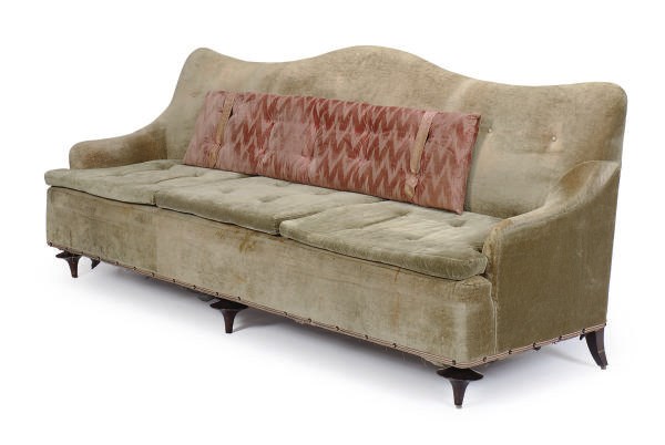 A GREEN UPHOLSTERED SOFA,