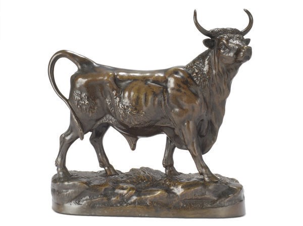 A PATINATED BRONZE FIGURE OF A BULL,