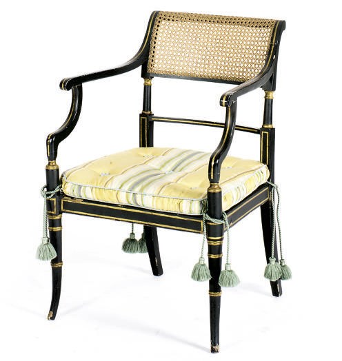 AN ENGLISH EBONIZED, PARCEL-GILT AND CANED OPEN ARMCHAIR,