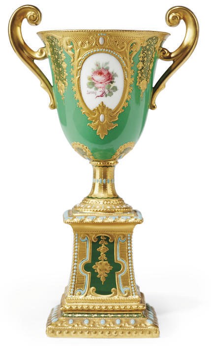 A ROYAL CROWN DERBY TWO-HANDLED GREEN-GROUND URN ON STAND