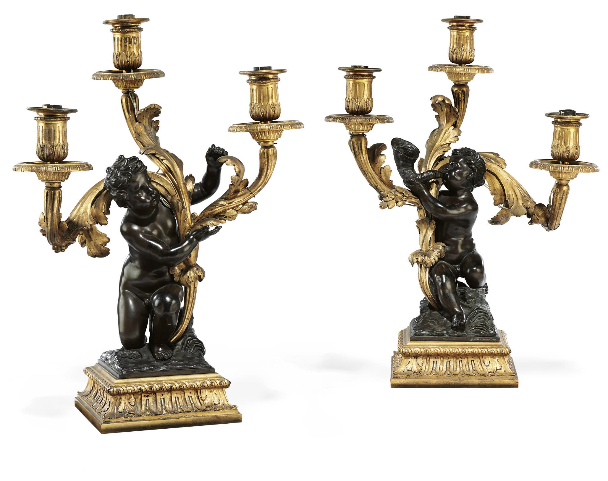 A PAIR OF FRENCH PATINATED-BRONZE AND ORMOLU THREE-BRANCH CANDELABRA