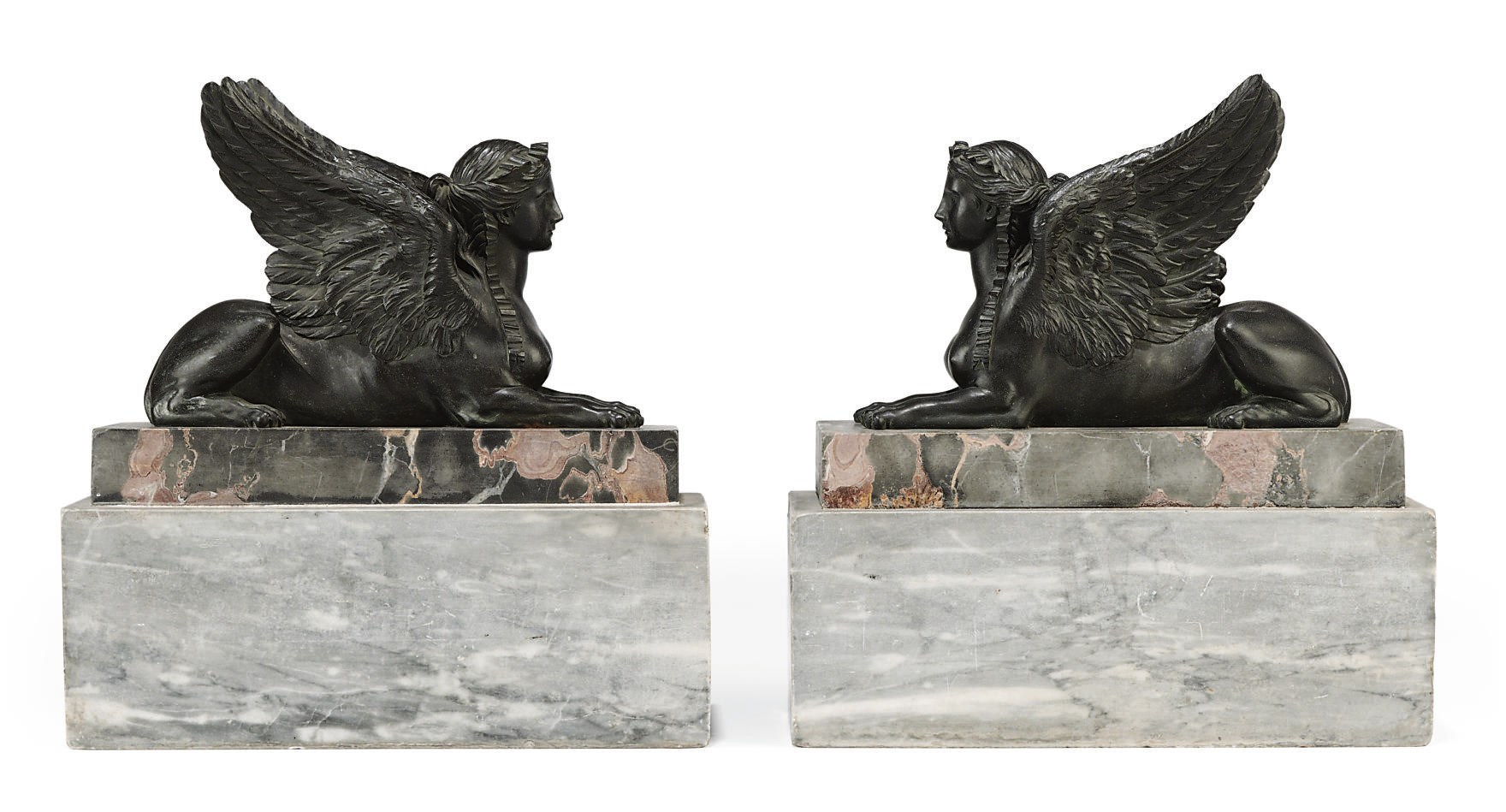 A PAIR OF EMPIRE BRONZE RECLINING SPHINXES