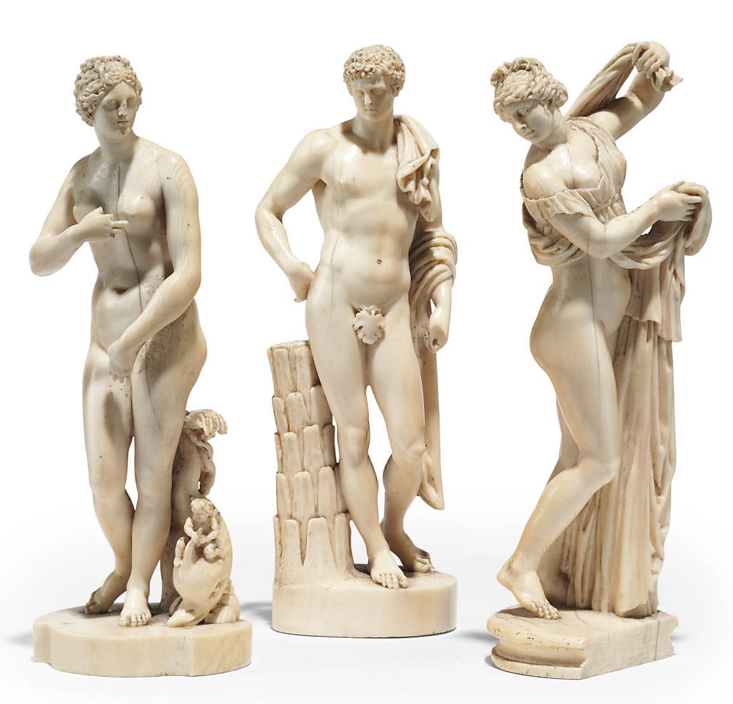 A SET OF THREE CARVED IVORY FIGURES OF THE VENUS DE' MEDICI, THE BELVEDERE ANTINOUS AND THE CALLYPIGIAN VENUS, AFTER THE ANTIQUE