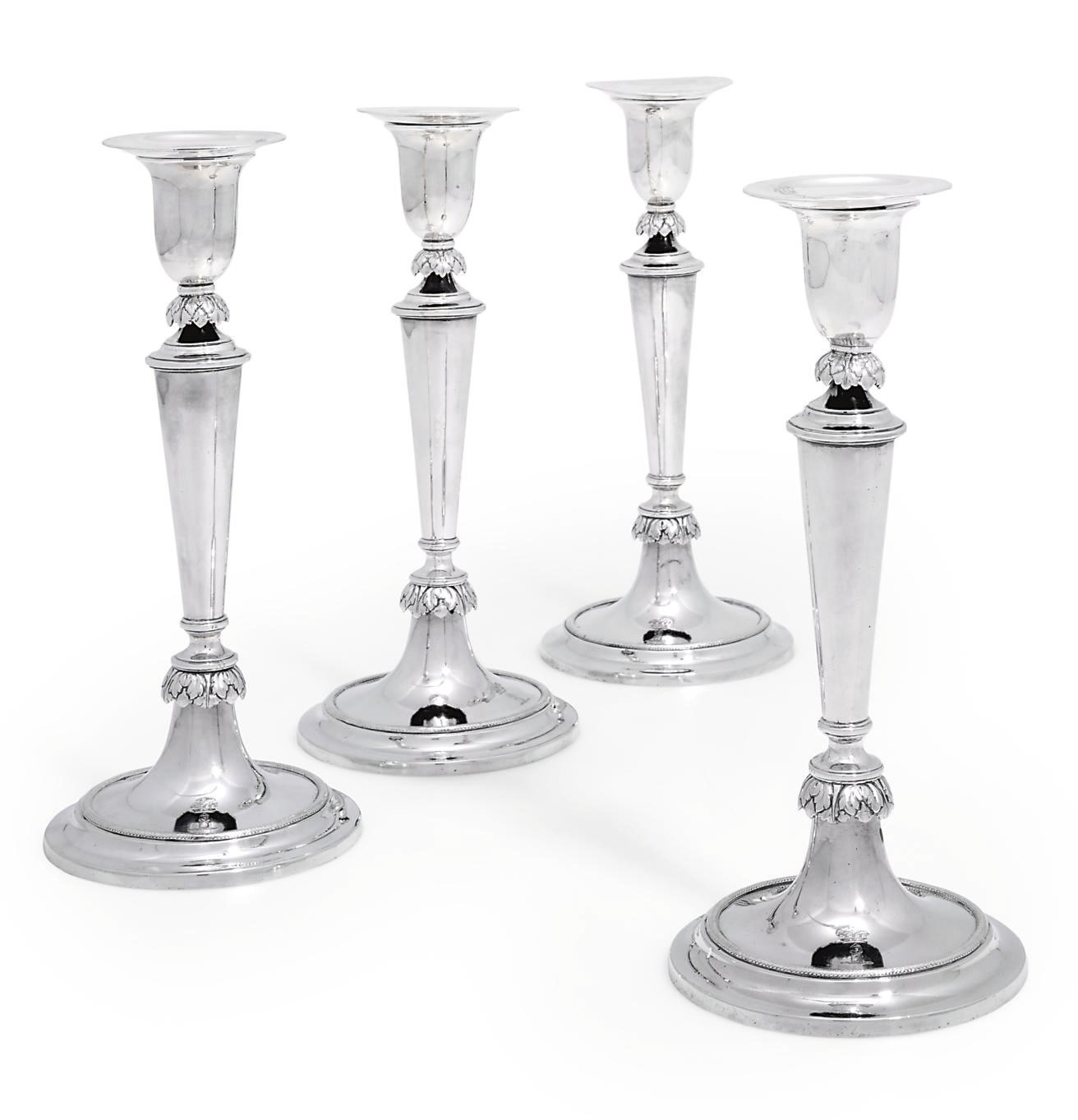 A SET OF FOUR RUSSIAN SILVER CANDLESTICKS