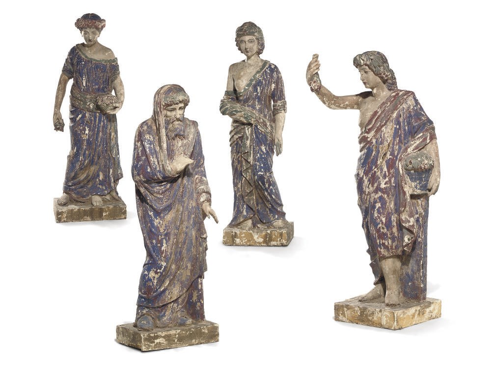 A SET OF FOUR INDIAN CARVED AND PAINTED WOOD FIGURES OF THE SEASONS