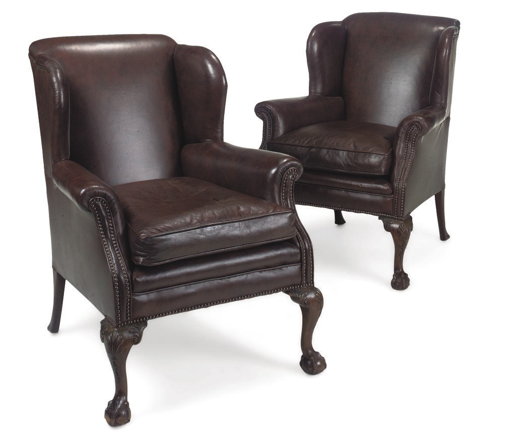 A PAIR OF MAHOGANY AND MAROON LEATHER UPHOLSTERED WING-ARMCHAIRS