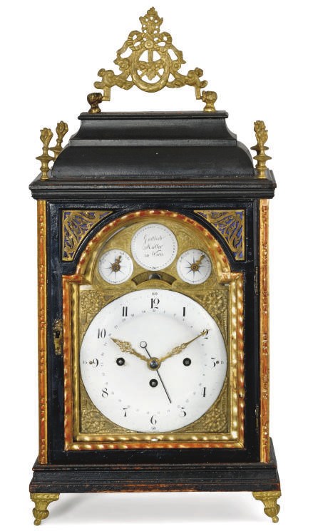 AN AUSTRIAN BRASS AND GILTWOOD-MOUNTED EBONISED GRANDE SONNERIE TABLE CLOCK