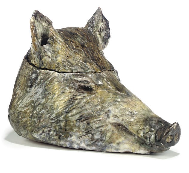 A CONTINENTAL GLAZED EARTHENWARE TUREEN MODELLED AS A BOAR'S HEAD