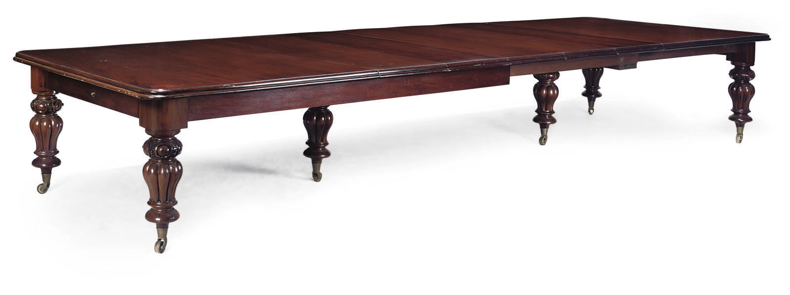 A LARGE MAHOGANY EXTENDING DINING TABLE