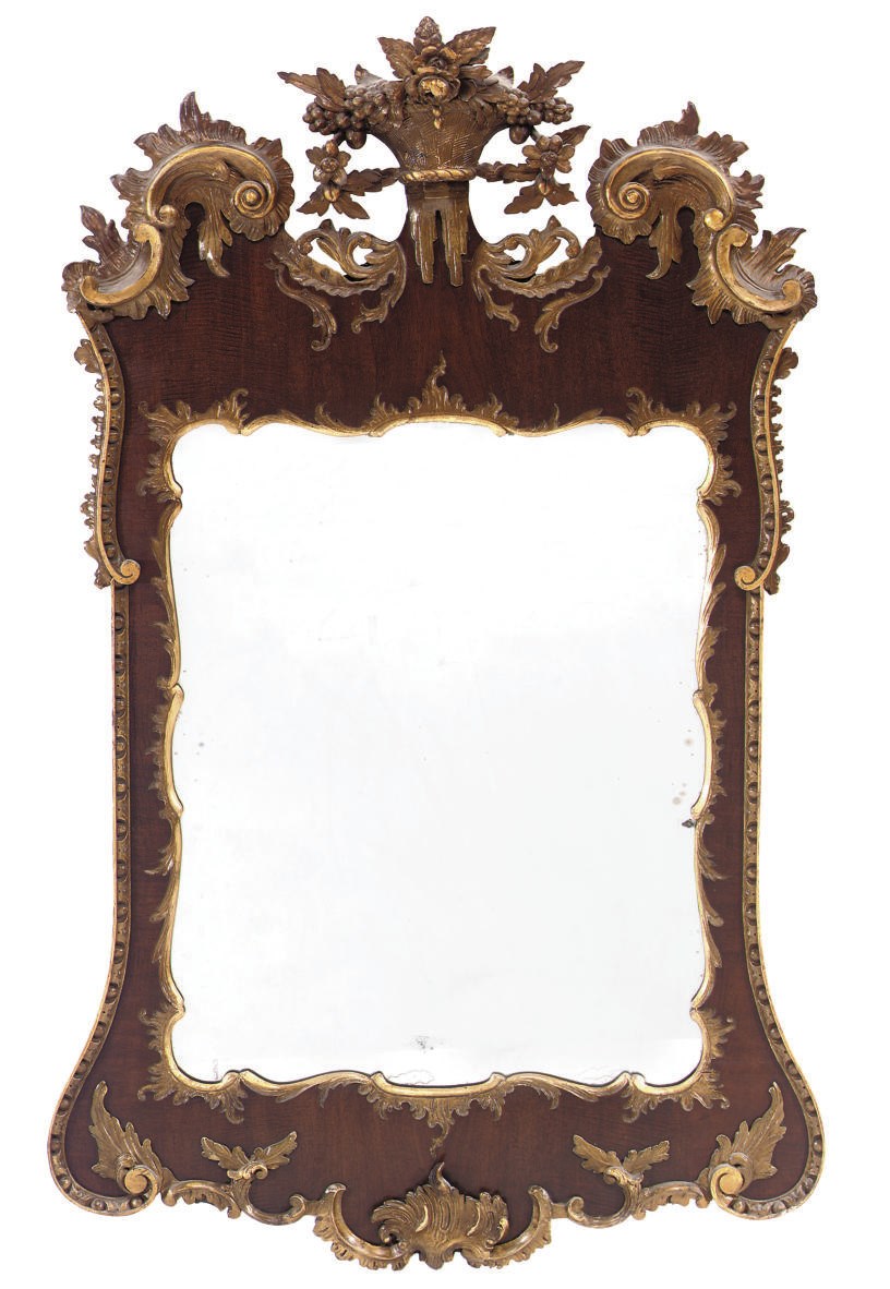 A PARCEL GILT AND MAHOGANY MIRROR