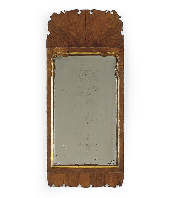 A NORTH EUROPEAN WALNUT AND PARCEL-GILT MIRROR,