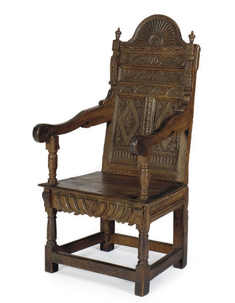 A CARVED OAK WAINSCOT ARMCHAIR