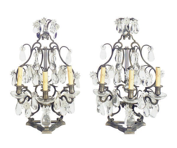 A PAIR OF PATINATED METAL, ROCK CRYSTAL AND MOLDED GLASS THREE-LIGHT GIRANDOLES,