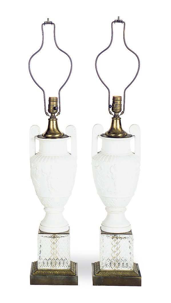 A PAIR OF BISQUE PORCELAIN RELIEF MOLDED VASES MOUNTED AS LAMPS,
