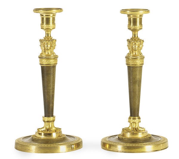A PAIR OF PATINATED AND GILT-METAL CANDLESTICKS,
