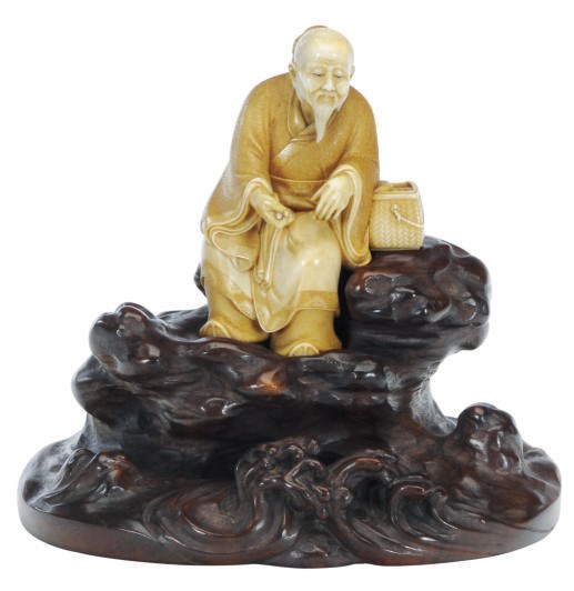 A JAPANESE CARVED IVORY FIGURE OF A SAGE ON CARVED WOOD AND IVORY INLAID STAND,**