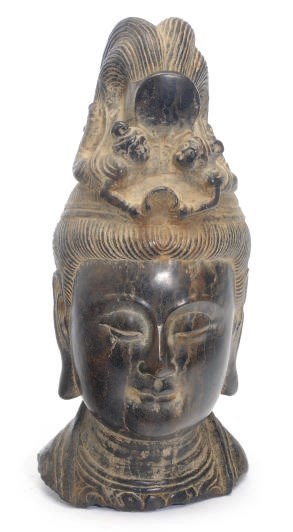 AN ASIAN CARVED STONE HEAD,