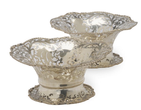 A PAIR OF GEORGE V RETICULATED SILVER BOTTLE STANDS,