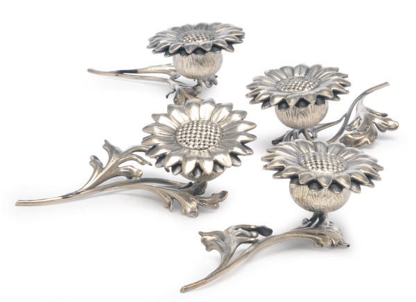 A SET OF FOUR ITALIAN SILVER FLORIFORM CASTERS, A SET OF EIGHT AMERICAN SILVER CASTERS AND TWO SETS OF NUT DISHES,