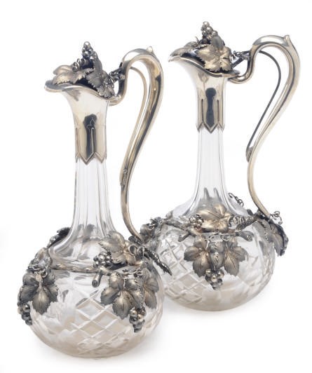 A PAIR OF AUSTRIAN SILVER-MOUNTED CUT GLASS DECANTERS WITH HINGED COVERS,