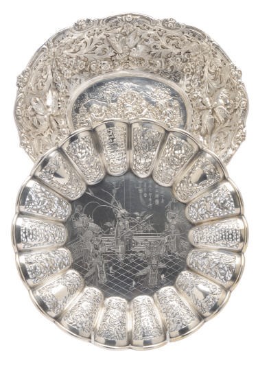 A CONTINENTAL SILVER OVAL DISH REPOUSSE WITH BIRDS AMONGST GARLANDS AND AN ASIAN SILVER DISH,