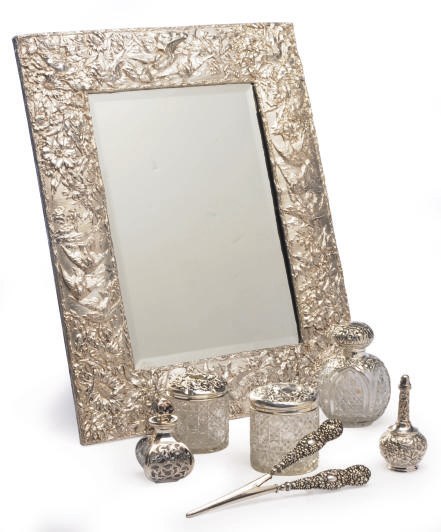 AN AMERICAN SILVER DRESSING MIRROR AND AN ASSEMBLED SILVER TOILETTE SERVICE,