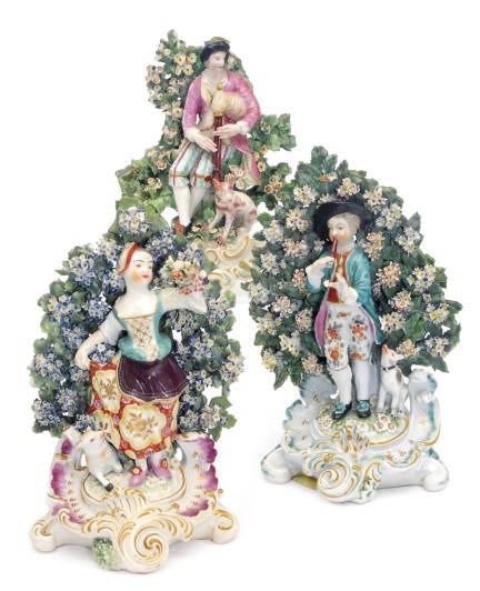 A PAIR OF STAFFORDSHIRE BOCAGE FIGURES OF A SHEPHERD AND SHEPHERDESS, AND A SIMILAR BOCAGE FIGURE OF A SHEPARD,