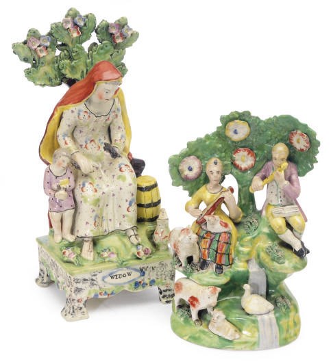 A STAFFORDSHIRE PEARLWARE BOCAGE TABLE GROUP OF A 'WIDOW' AND SHEPHERD AND SHEPHERDESS AS MUSICIANS,