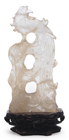 A CHINESE CARVED ROCK CRYSTAL OF A PHOENIX ON ROCKWORK,