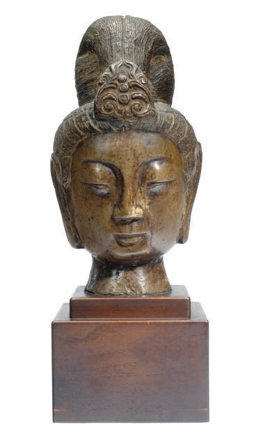 A TANG-STYLE CARVED STONE HEAD OF GUANYIN ON WOOD STAND,