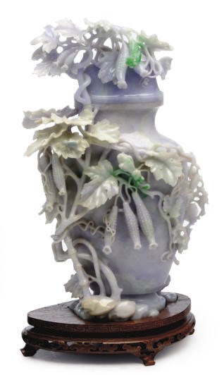 A CHINESE CARVED PALE LAVENDER AND GREEN JADEITE VASE AND COVER,