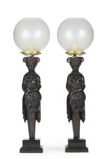 A PAIR OF CONTINENTAL EBONIZED COMPOSITION FIGURAL TABLE LAMPS,