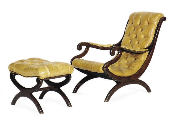 A MAHOGANY AND BUTTON-TUFFTED LEATHER UPHOLSTERED LOUNGE CHAIR AND OTTOMAN,