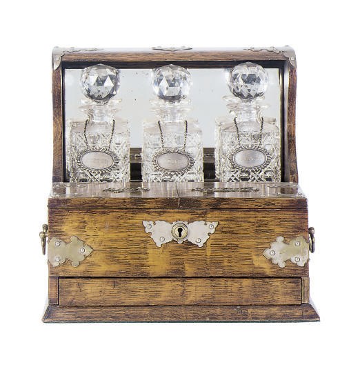 A VICTORIAN OAK TANTALUS,