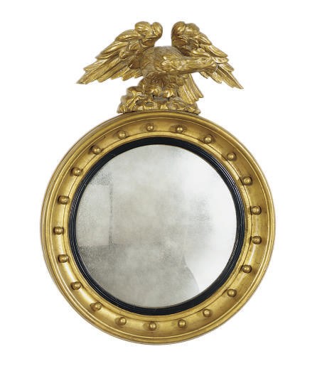 A REGENCY GILTWOOD AND PART-EBONIZED FIGURAL CONVEX MIRROR,
