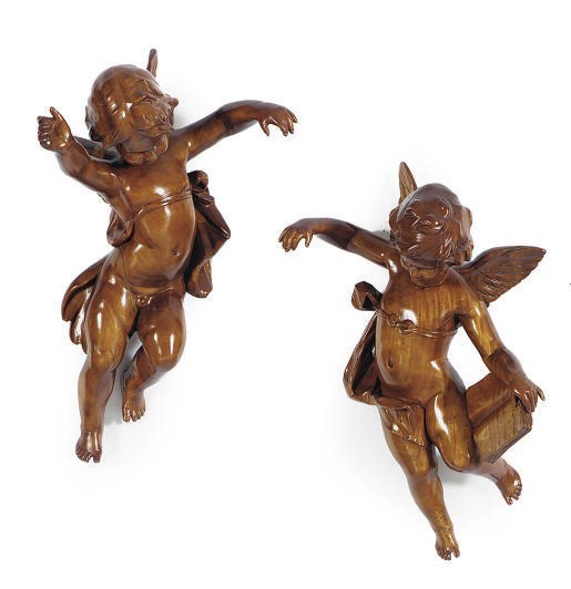 A PAIR OF MAHOGANY FIGURES OF PUTTI,