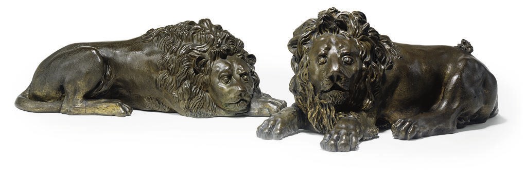 A PAIR OF FRENCH OR ITALIAN BRONZE MODELS OF RECUMBENT LIONS