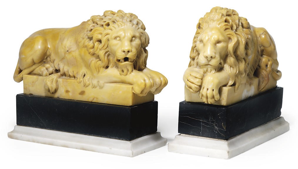 A PAIR OF ITALIAN SIENA MARBLE MODELS OF LIONS