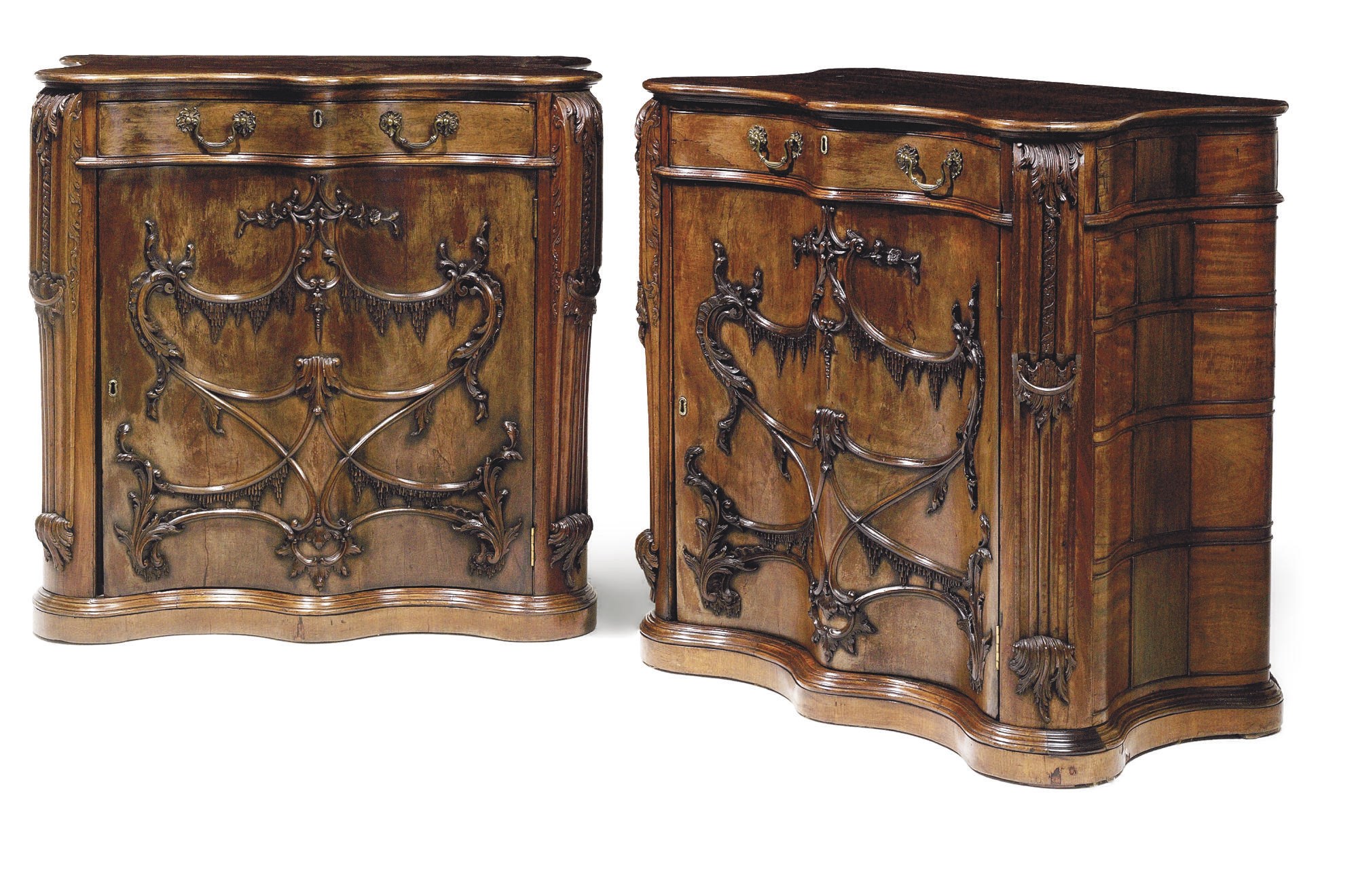 A PAIR OF EDWARDIAN MAHOGANY SERPENTINE SIDE CABINETS