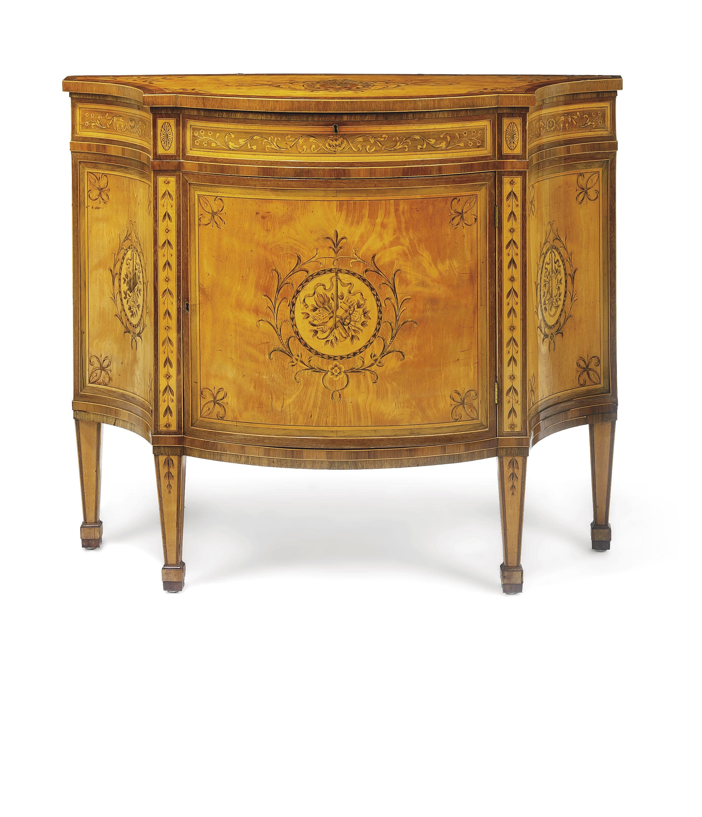A GEORGE III SATINWOOD, AMARANTH, MAHOGANY, HAREWOOD AND MARQUETRY SERPENTINE COMMODE