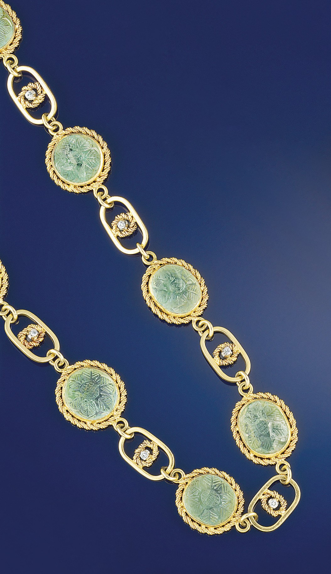 A carved emerald and diamond set necklace