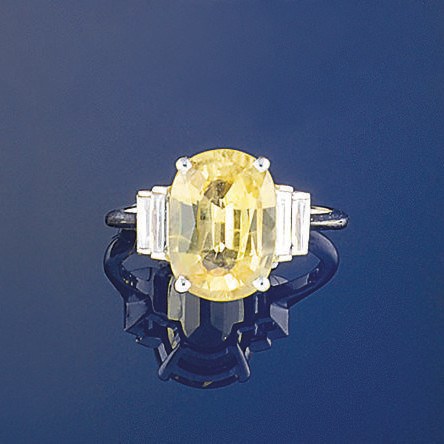 A yellow sapphire and diamond  ring
